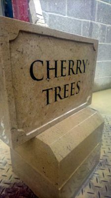 Stone house name sign